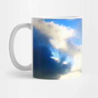 Blue sky covered with dark and light clouds Mug